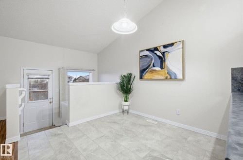 Unfurnished dining area with vaulted ceiling and baseboards - 608 87 St, Edmonton, AB - Indoor Photo Showing Other Room