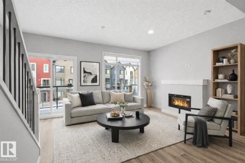 80 1010 Rabbit Hill Road, Edmonton, AB - Indoor Photo Showing Living Room With Fireplace
