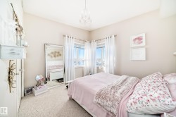 Carpeted bedroom featuring a chandelier - 