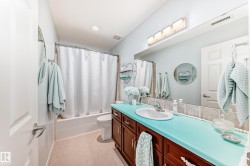 Bathroom featuring vanity and shower / bathtub combination with curtain - 