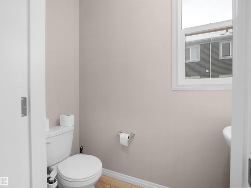 Bathroom with toilet and baseboards - 2080 Wonnacott Way, Edmonton, AB - Indoor Photo Showing Bathroom