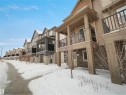 Snow covered building featuring a residential view - 2080 Wonnacott Way, Edmonton, AB  - Outdoor With Balcony With Facade 