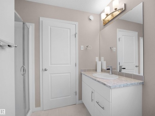 Full bathroom with vanity, a shower stall, and a textured ceiling - 2080 Wonnacott Way, Edmonton, AB - Indoor Photo Showing Bathroom