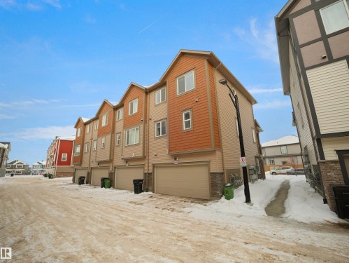 Back of property with a residential view and stone siding - 2080 Wonnacott Way, Edmonton, AB - Outdoor With Exterior