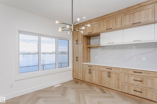 Kitchen with light brown cabinets, a chandelier, decorative backsplash, hanging light fixtures, and recessed lighting - 220 Edgemont Green Green, Edmonton, AB - Indoor Photo Showing Other Room