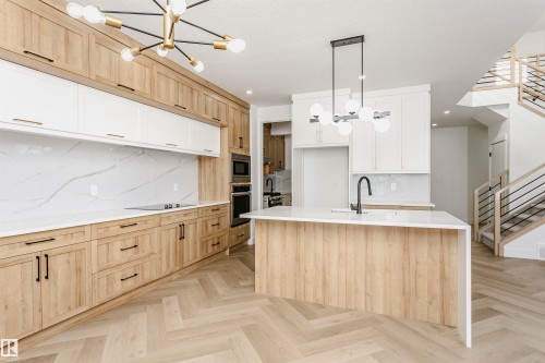 Kitchen featuring a chandelier, light brown cabinets, and a center island with sink - 220 Edgemont Green Green, Edmonton, AB - Indoor Photo Showing Kitchen