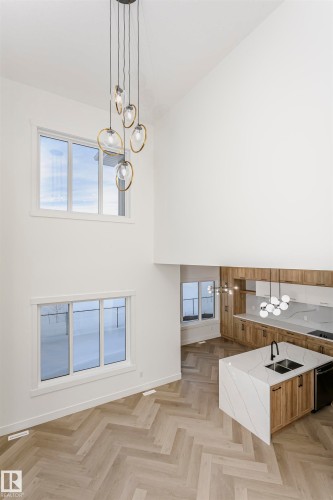 Interior space featuring pendant lighting, a chandelier, light stone countertops, and plenty of natural light - 220 Edgemont Green Green, Edmonton, AB - Indoor