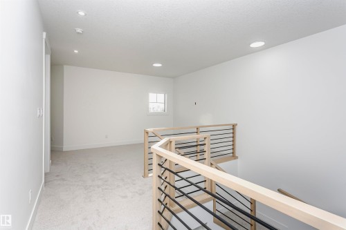 Hall featuring an upstairs landing, light colored carpet, a textured ceiling, and recessed lighting - 220 Edgemont Green Green, Edmonton, AB - Indoor Photo Showing Other Room