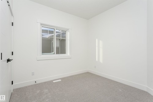Carpeted empty room with baseboards - 220 Edgemont Green Green, Edmonton, AB - Indoor Photo Showing Other Room
