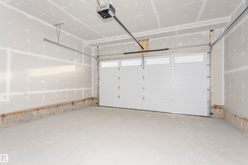 Garage with a garage door opener - 220 Edgemont Green Green, Edmonton, AB - Indoor Photo Showing Garage
