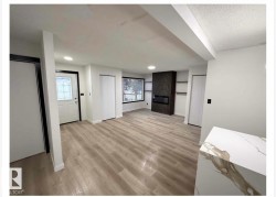 Unfurnished living room with light wood-style floors and a textured ceiling - 