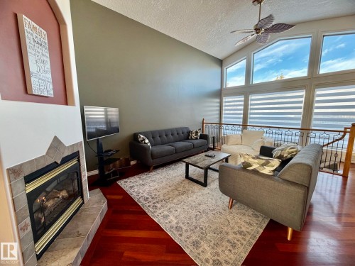 1207 Oakland Drive, Devon, AB - Indoor Photo Showing Living Room With Fireplace