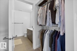 Bathroom with vanity and light tile patterned floors - 