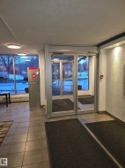 Community lobby featuring a textured ceiling and a textured wall - 