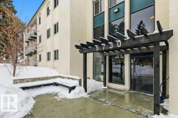 View of exterior entry featuring a pergola, stucco siding, and a patio - 
