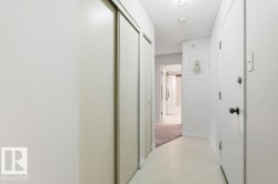 Hallway with light floors and a textured ceiling - 
