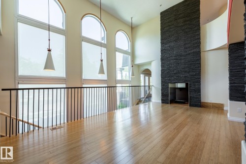 Unfurnished living room featuring hardwood / wood-style floors and a towering ceiling - 12428 103 Avenue, Edmonton, AB - Indoor Photo Showing Other Room