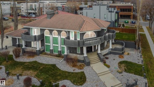 View of front of property with a tiled roof, stucco siding, and a porch - 12428 103 Avenue, Edmonton, AB - Outdoor