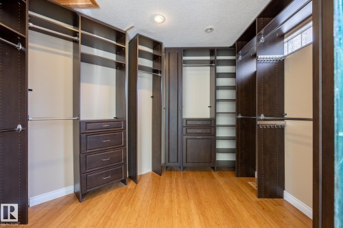 Walk in closet featuring light wood-style flooring - 12428 103 Avenue, Edmonton, AB - Indoor Photo Showing Other Room