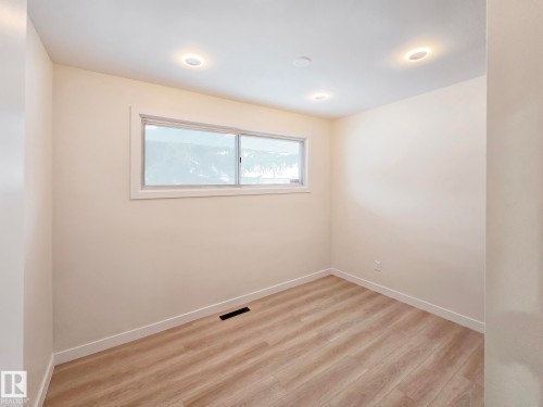 Spare room featuring light wood-style floors and baseboards - 13711 133 Avenue, Edmonton, AB - Indoor Photo Showing Other Room