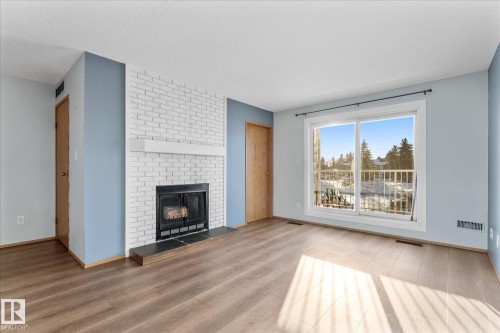 209 70 Alpine Place, St. Albert, AB - Indoor Photo Showing Living Room With Fireplace