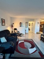 Living area with light wood-style flooring and baseboards - 