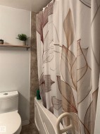 Full bath featuring toilet and shower / tub combo with curtain - 