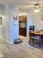 Dining room featuring a textured ceiling, light wood finished floors, and a ceiling fan - 