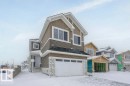 View of front of house with stone siding and a garage - 804 Elderberry Crest, Edmonton, AB  - Outdoor With Facade 