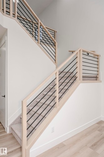 Staircase featuring wood finished floors and baseboards - 804 Elderberry Crest, Edmonton, AB - Indoor Photo Showing Other Room