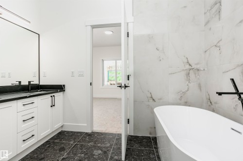 Full bathroom with a freestanding tub, vanity, and tile walls - 804 Elderberry Crest, Edmonton, AB - Indoor Photo Showing Bathroom