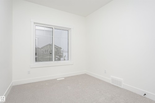 Carpeted empty room featuring baseboards - 804 Elderberry Crest, Edmonton, AB - Indoor Photo Showing Other Room