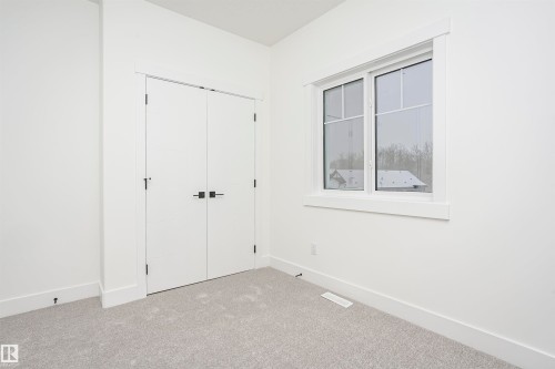 Unfurnished bedroom with carpet floors and a closet - 804 Elderberry Crest, Edmonton, AB - Indoor Photo Showing Other Room