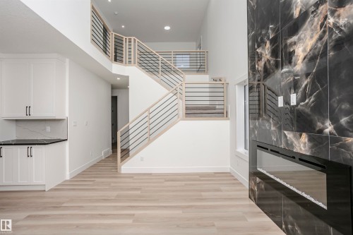 Stairs with a towering ceiling, wood finished floors, and recessed lighting - 804 Elderberry Crest, Edmonton, AB - Indoor Photo Showing Other Room