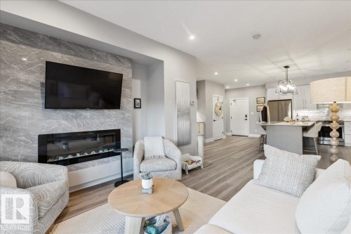 301 7463 May Common, Edmonton, AB - Indoor Photo Showing Living Room With Fireplace