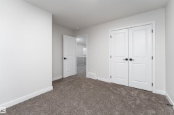 Unfurnished bedroom with dark carpet and a closet - 
