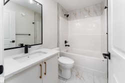 Full bath with vanity,  shower combination, and light marble finish flooring - 