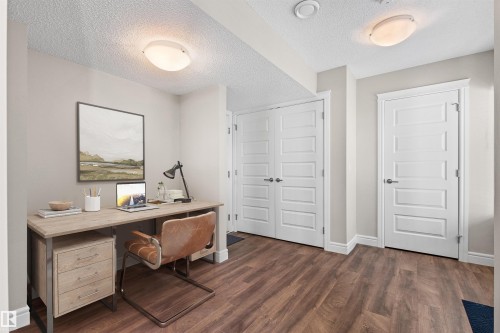 Office area featuring dark wood-type flooring and a textured ceiling - 36 330 Bulyea Road, Edmonton, AB - Indoor Photo Showing Office