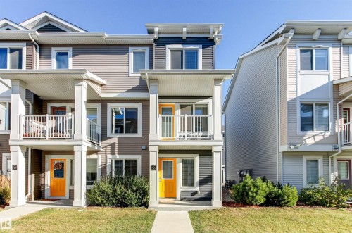 View of front facade with a balcony, a front yard, and a residential view - 36 330 Bulyea Road, Edmonton, AB - Outdoor With Facade