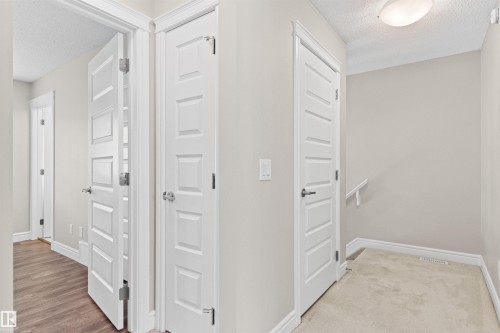 Corridor with a textured ceiling and light wood-style flooring - 36 330 Bulyea Road, Edmonton, AB - Indoor Photo Showing Other Room