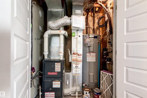 Utilities featuring electric water heater and heating unit - 36 330 Bulyea Road, Edmonton, AB - Indoor Photo Showing Basement