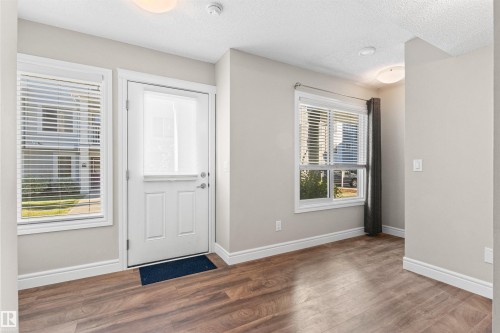 Entryway featuring wood finished floors and a textured ceiling - 36 330 Bulyea Road, Edmonton, AB - Indoor Photo Showing Other Room