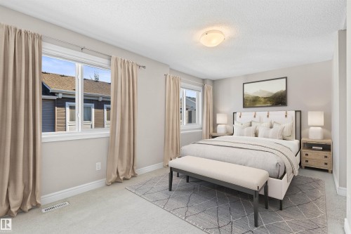 Bedroom featuring light carpet and a textured ceiling - 36 330 Bulyea Road, Edmonton, AB - Indoor Photo Showing Bedroom
