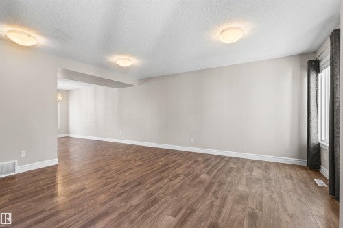 Spare room with a textured ceiling and dark wood-type flooring - 36 330 Bulyea Road, Edmonton, AB - Indoor Photo Showing Other Room