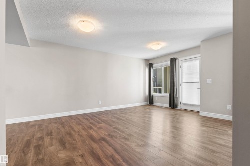 Unfurnished room with wood finished floors and a textured ceiling - 36 330 Bulyea Road, Edmonton, AB - Indoor Photo Showing Other Room