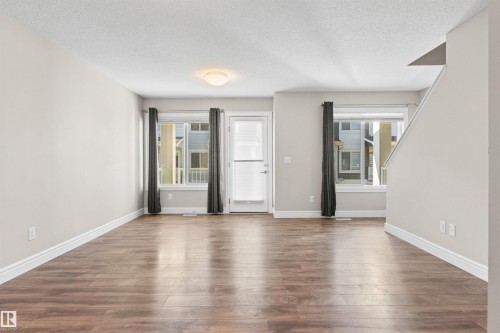 Unfurnished room with a textured ceiling and wood finished floors - 36 330 Bulyea Road, Edmonton, AB - Indoor Photo Showing Other Room