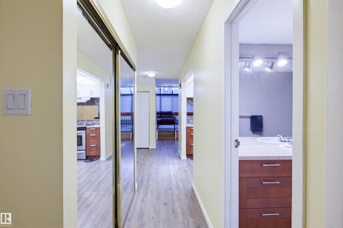 Hall featuring a textured ceiling and light wood-style flooring - 11108 83 Avenue Nw, Edmonton, AB - Indoor Photo Showing Other Room