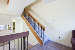 Staircase with wood finished floors and baseboards - 