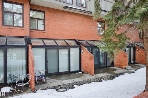 View of exterior entry with brick siding and a patio area - 11108 83 Avenue Nw, Edmonton, AB - Outdoor With Exterior