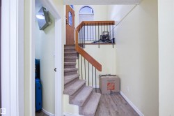 Stairs featuring wood finished floors and a textured ceiling - 